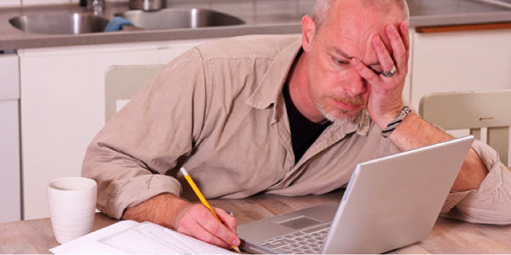 Stressed tradie at laptop